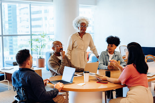 Business meeting among diverse team at round table