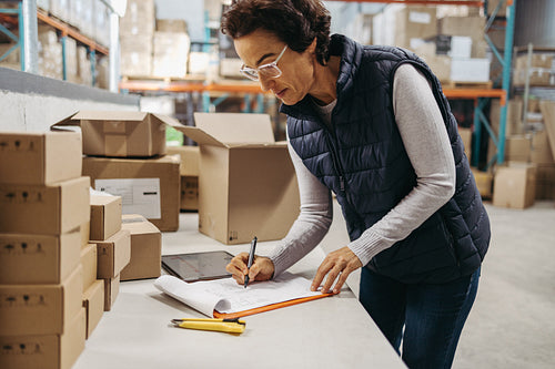 Warehouse worker writing a waybill