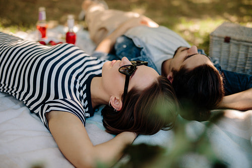 Woman with boyfriend relaxing at picnic