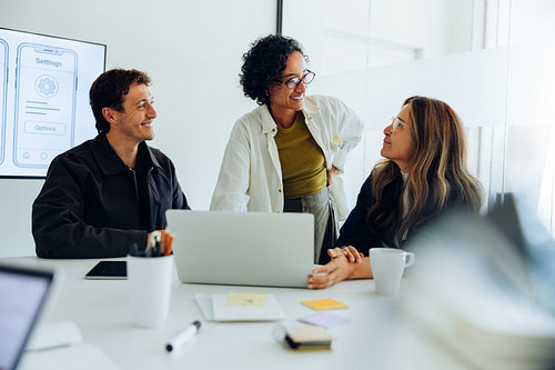 Design team collaborating on UX strategy in modern office