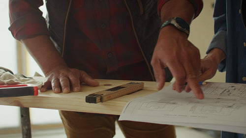 Vision in progress: Couple reviewing blueprints for home renovation