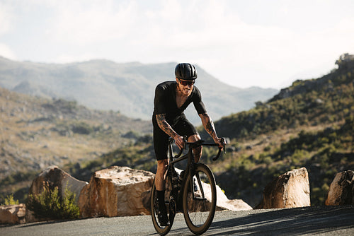 Cyclist pedals uphill during training