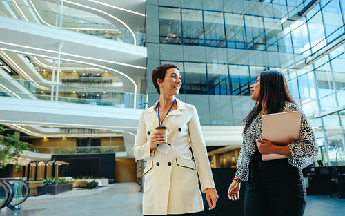 Professional colleagues discussing business strategies in a state-of-the-art corporate building