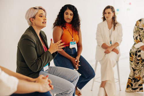 Creative businesswomen having a discussion during a conference m
