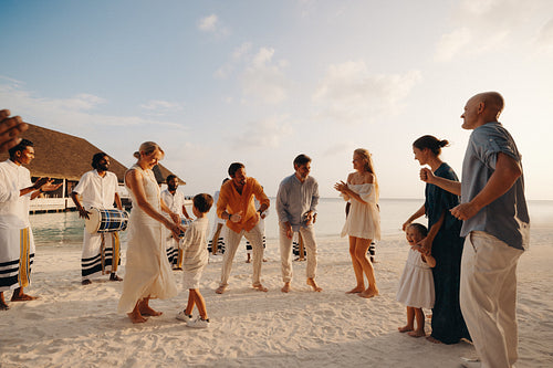 Family enjoying a holiday celebration on a Maldives beach