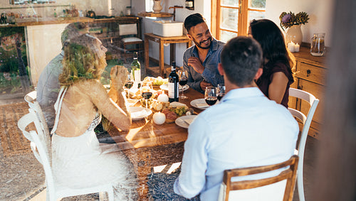Friends talking over lunch at home