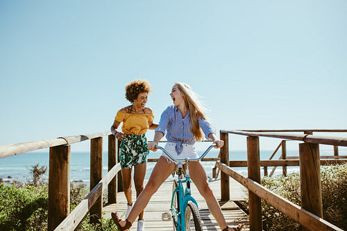 Friends enjoying themselves with a bike