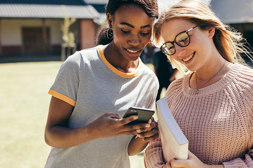 High school girls at college campus with smart phone