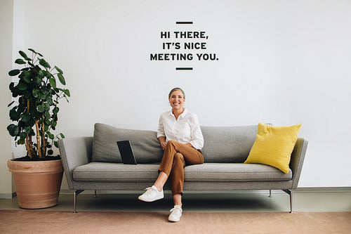 Mature businesswoman looking happy at lobby