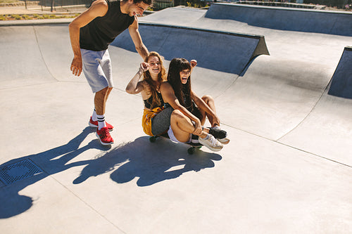 Group of friends having fun at skate park