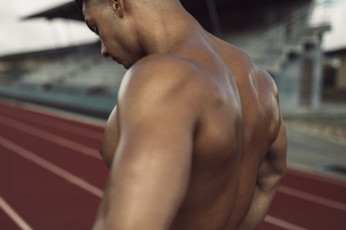 Muscular male runner taking break from training