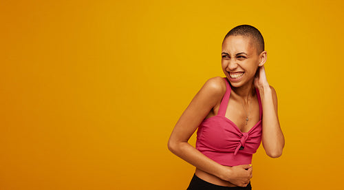 Stylish female model on yellow background