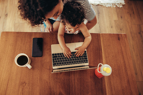 Woman watching her baby using laptop