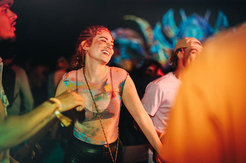 Summer partying with friends: Group of young people having fun at a musical concert
