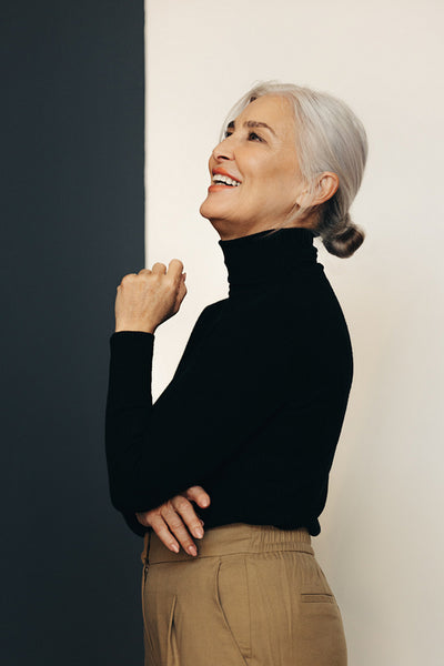 Empowered senior woman standing in an office, dressed in classy businesswear
