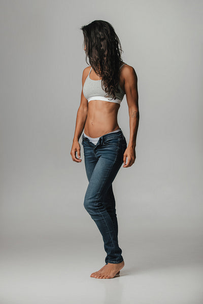 Strong beautiful tanned woman wearing halter top