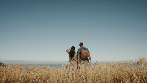 Hiking couple looking at the view from a mountain