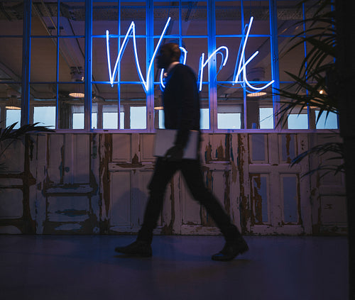 Corridor of a modern office with executive passing by
