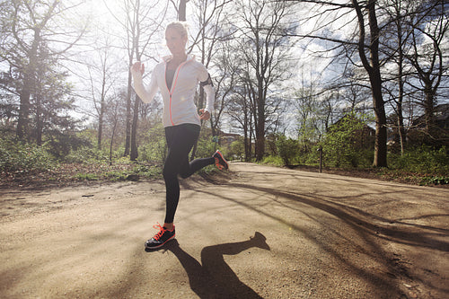 Young woman running outdoors in forest