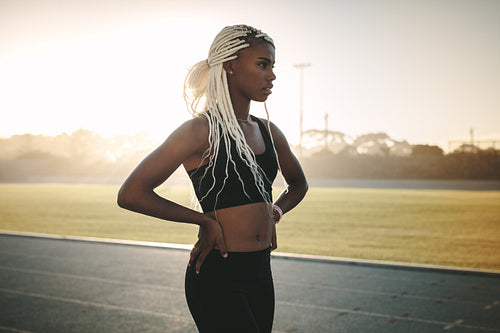 Female athlete walking on running track