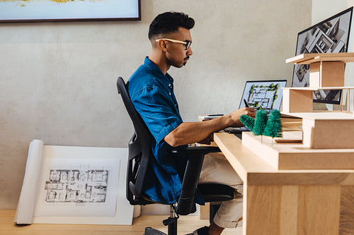 Young architect designing modern buildings at a professional workspace