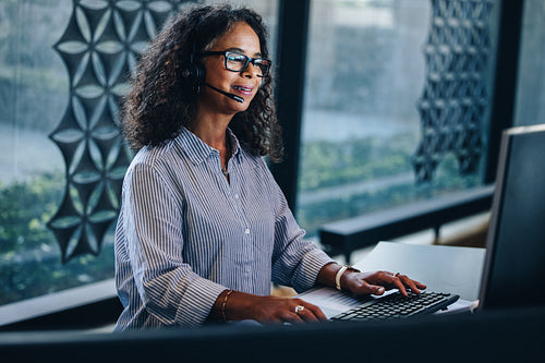 Mature business woman talking on headset