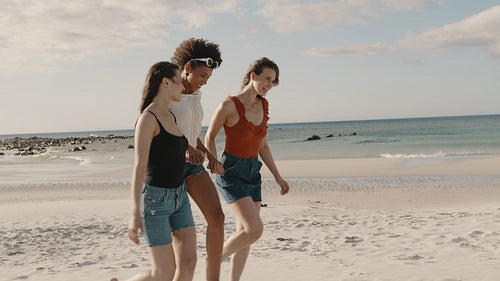 Group of three friends enjoying on the beach