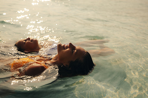 Blissful family moment during a sunset swim in clear water