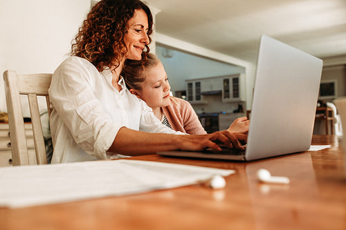 Working mother doing her work at home
