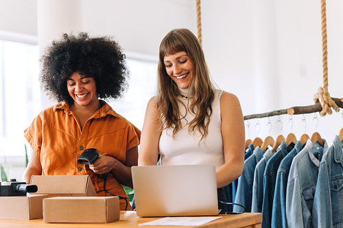 Cheerful young businesswomen working together in an online thrift store