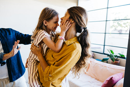 Family moment as mother hugs daughter