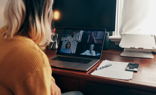 Businesswoman attending a virtual meeting while working from hom