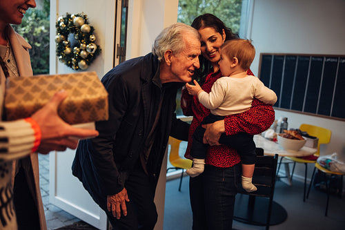 Senior couple visiting family for Christmas dinner
