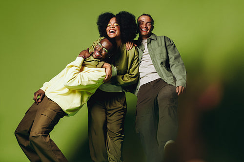 Young friends having fun in a cheerful studio portrait with happy chemistry
