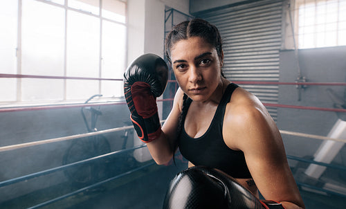 Female boxer training inside a boxing ring