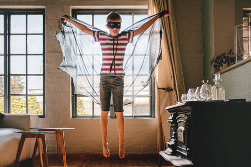 Boy in bat costume at home
