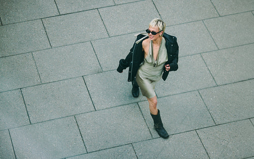 Urban solitude, woman walking alone through a city street