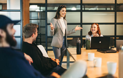 Successful project discussion: Diverse business professionals collaborating in a creative boardroom