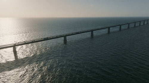 Storebæltsbroen Bridge at sunset, with a flow of coastal traffic on the roadway
