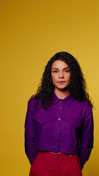 Confident young woman poses in vibrant studio portrait