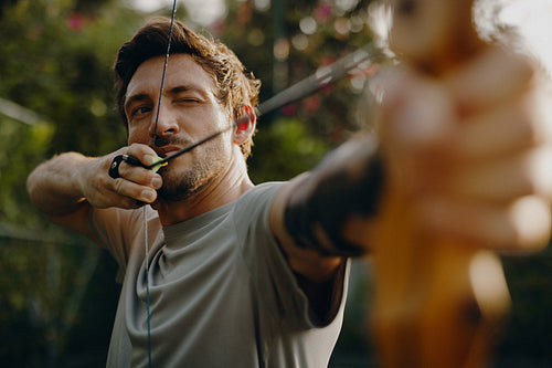 Focused archer aiming with bow