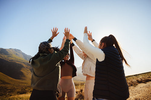 Group celebrating teamwork in scenic outdoors