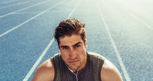 Sprinter relaxing on running track