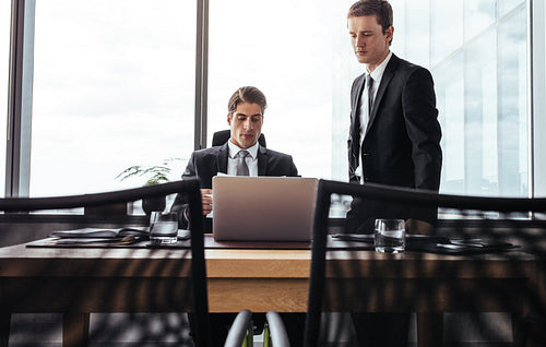 Business partners working together on laptop