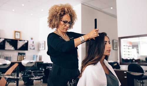 Woman hairdresser at work in salon
