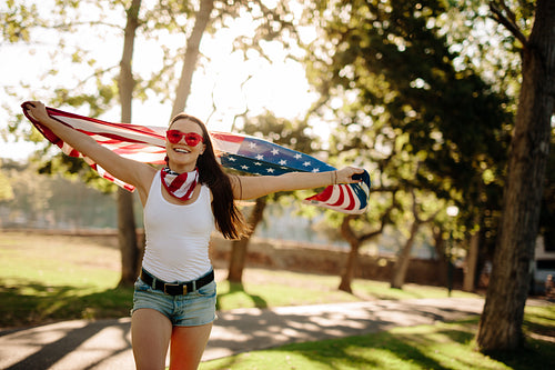 American woman celebrating independence day at park