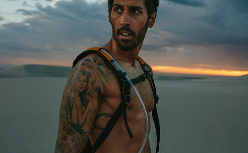 Man taking break from workout in desert