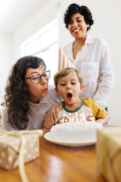 Lesbian parents with boy kid celebrating birthday