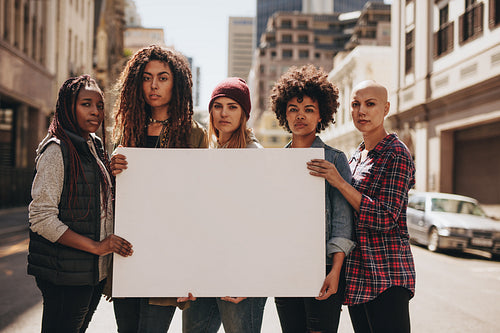 Female protesters with blank banner