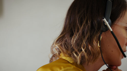 Customer service professional laughing during an online meeting